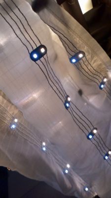 Closeup of an LED textile light with the conductive traces and both tungsten and daylight emittters visible