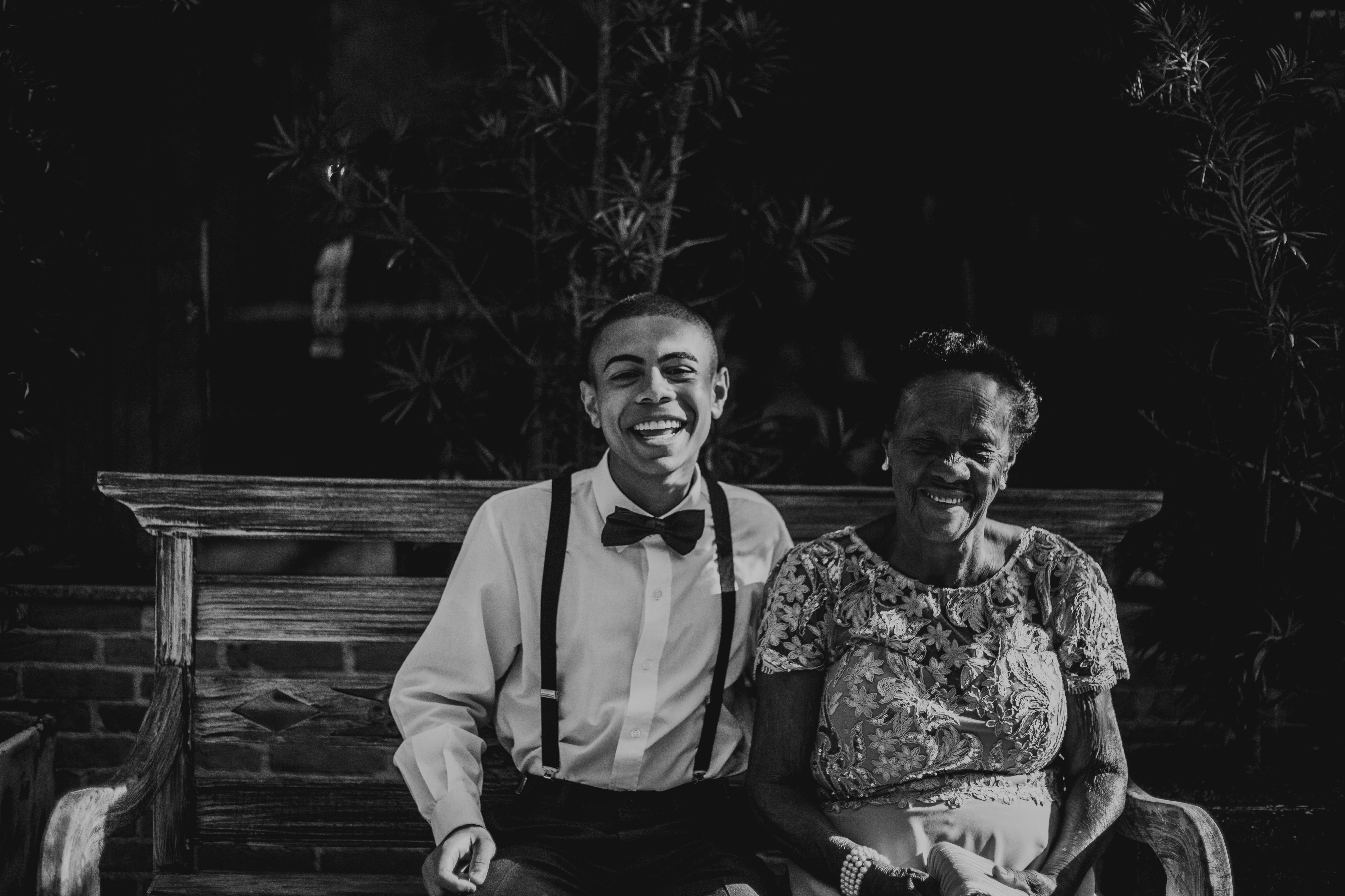 man-and-woman-sitting-on-bench-in-grayscale-photography-1049557