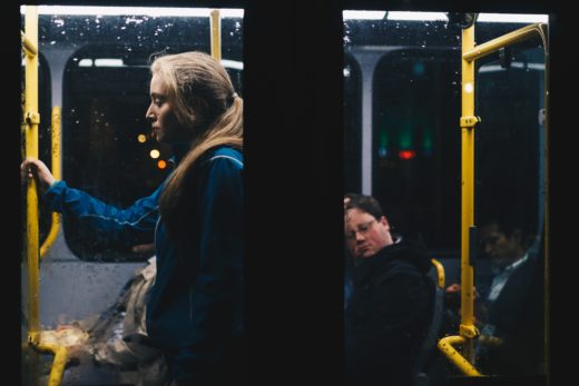 A young woman on public transport at night