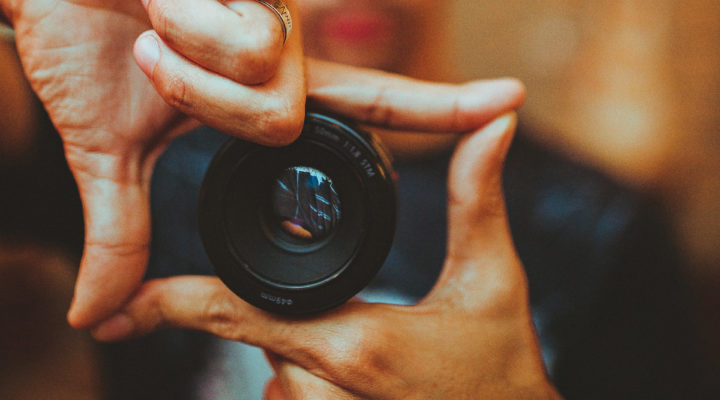 A photographer marking a frame with his fingers