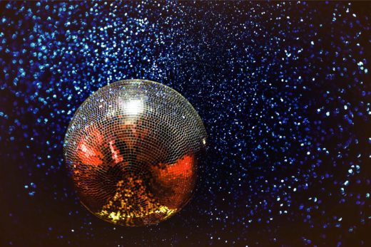 A mirrorball suspended against stars.