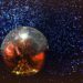 A mirrorball suspended against stars.