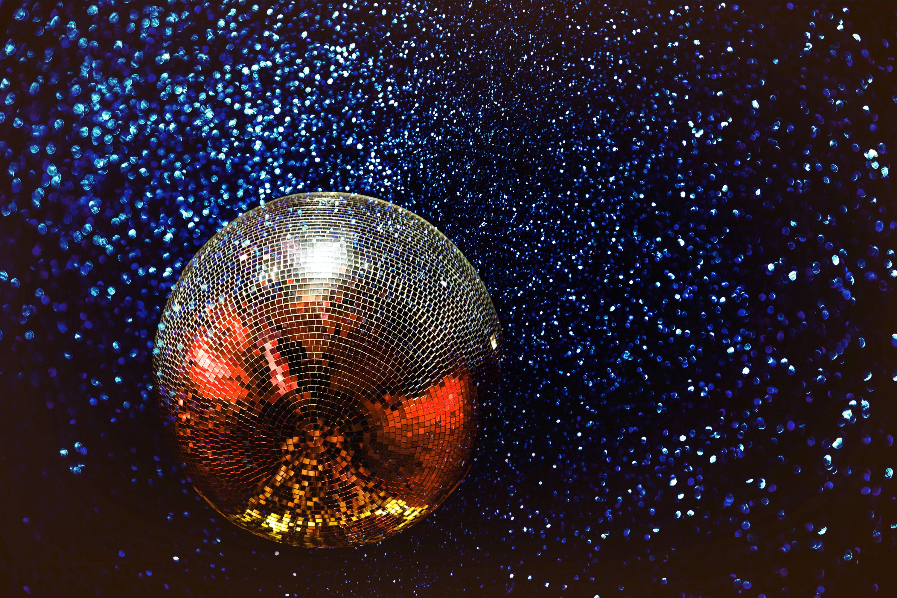 A mirrorball suspended against stars.